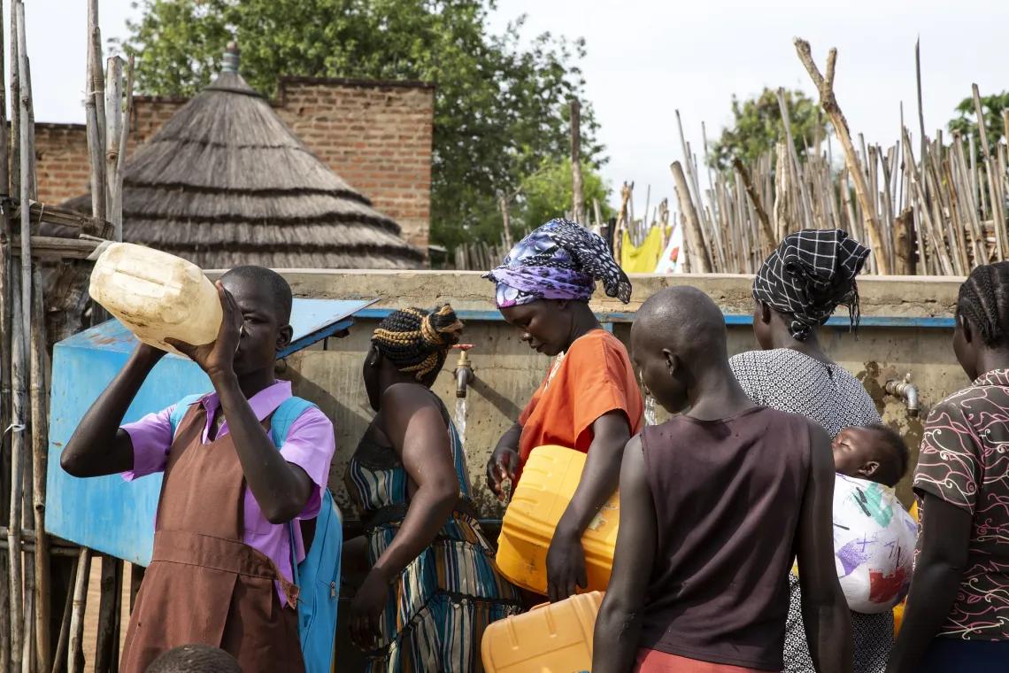 People gathered near thatched homes