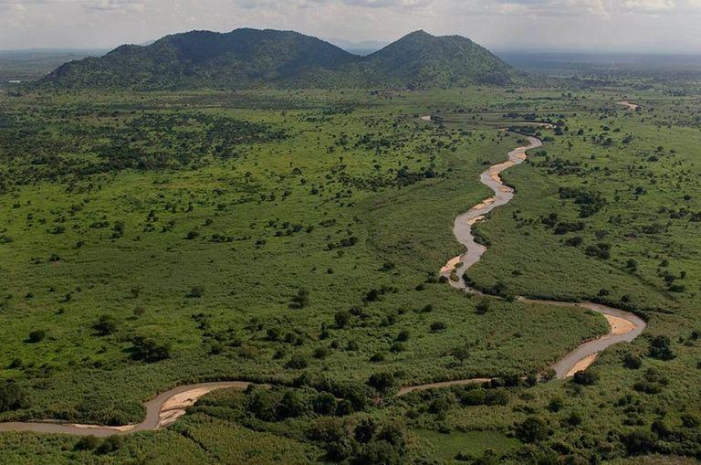 An aerial view of a river winding through green countryside